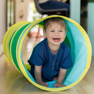 Child inside Organic Cotton Play Tunnel