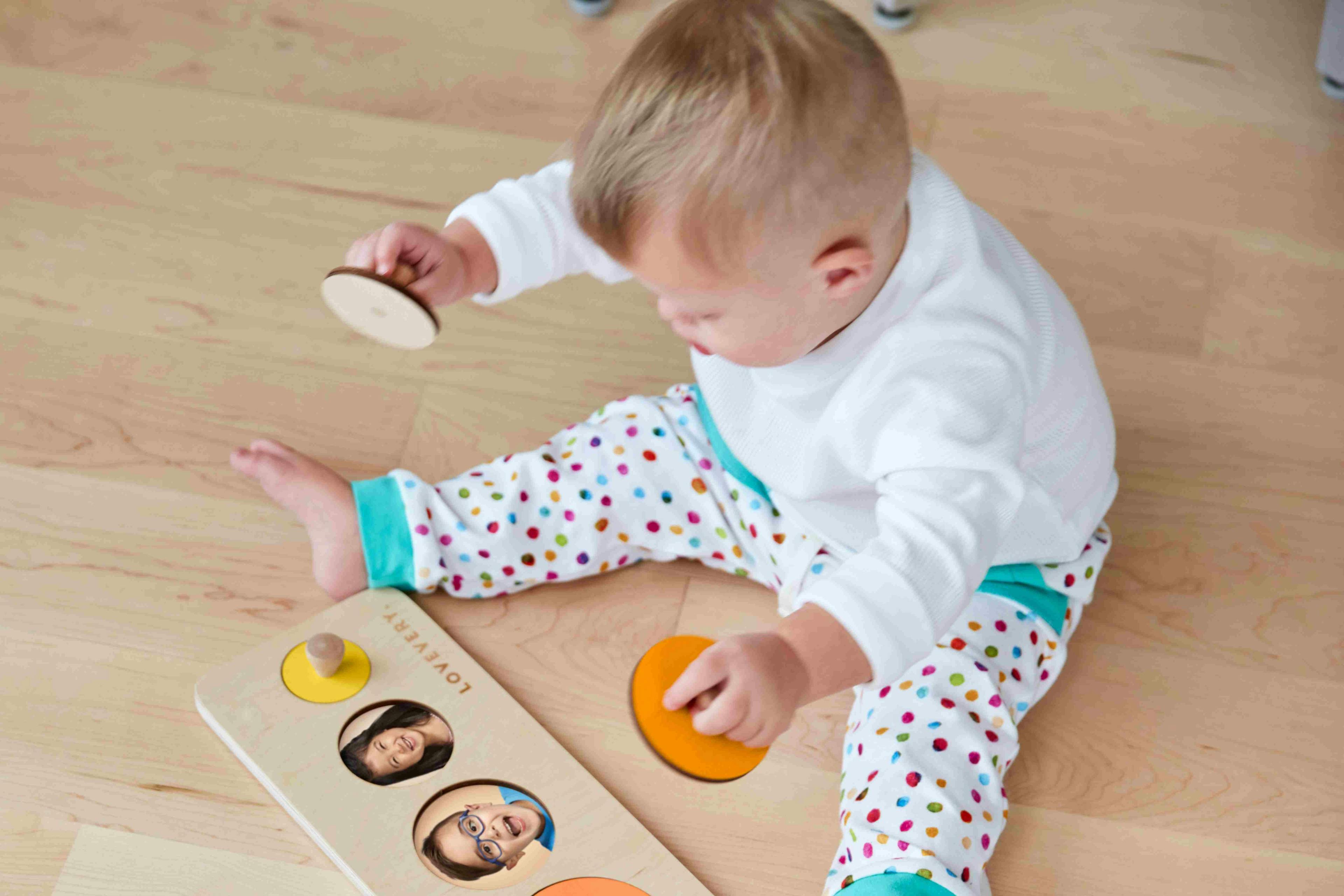 Child playing with the Circle of Friends Puzzle from The Babbler Play Kit